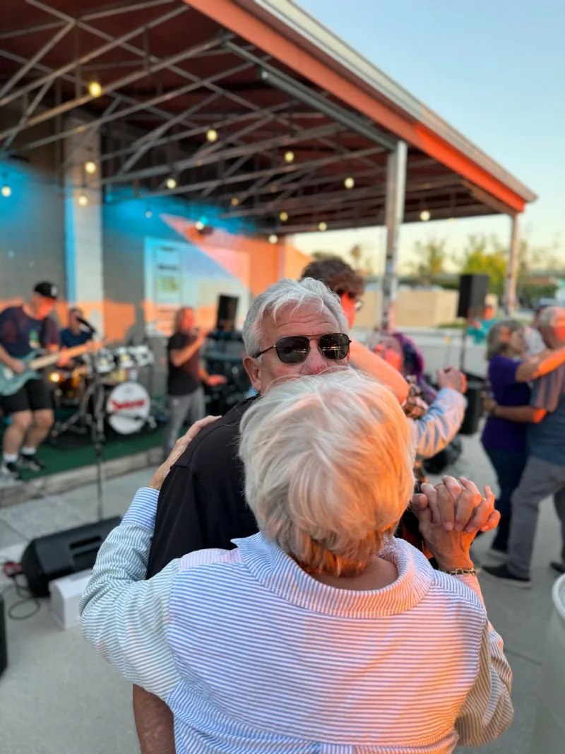 Couple dancing in front of the outdoor stage at Swan Brewing