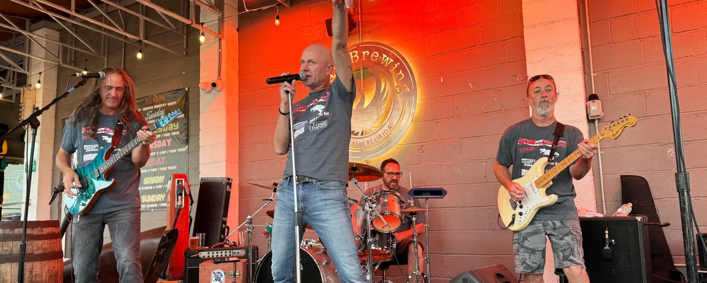 Live band performing on the outdoor stage at Swan Brewing